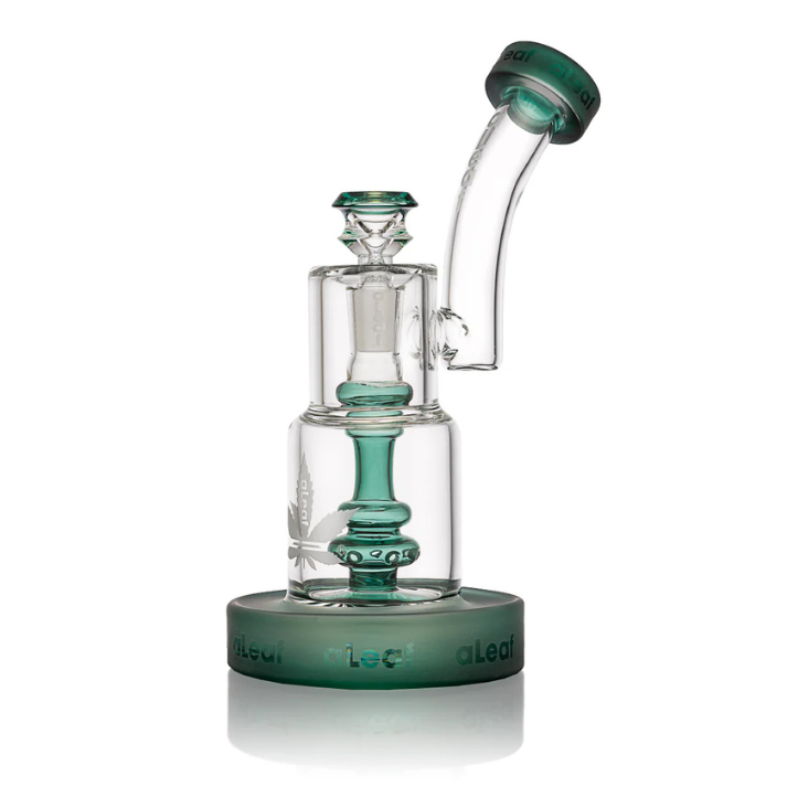 Clear glass smoking device with green accents on a white background